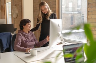 Two of ThinkData's female employees at a computer